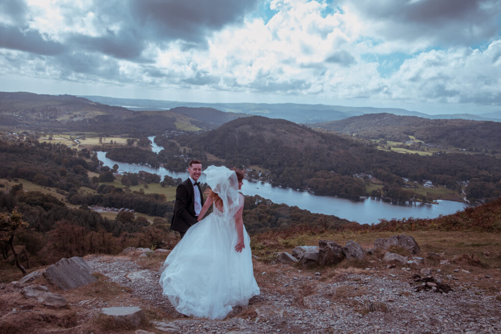 bride and groom in front of the lake district fells