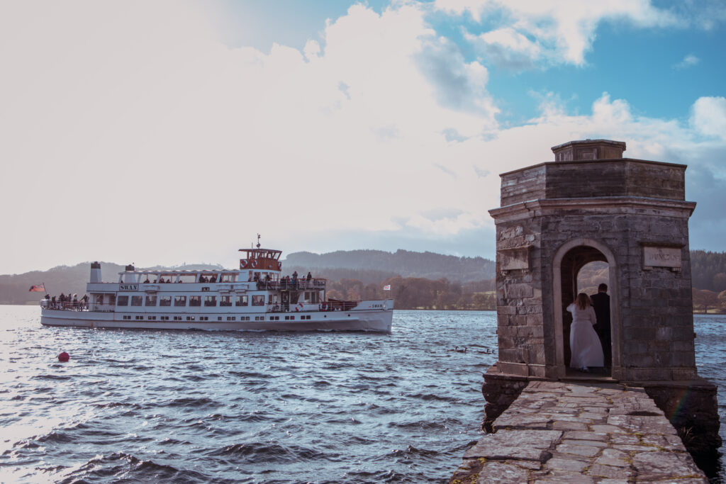 wedding celebration as boat passes on lake windermere