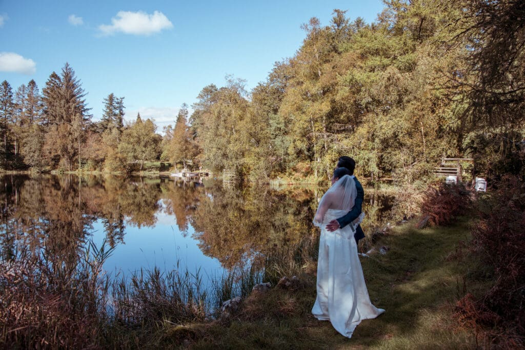 married couple infront of the lake at gilpin lake house