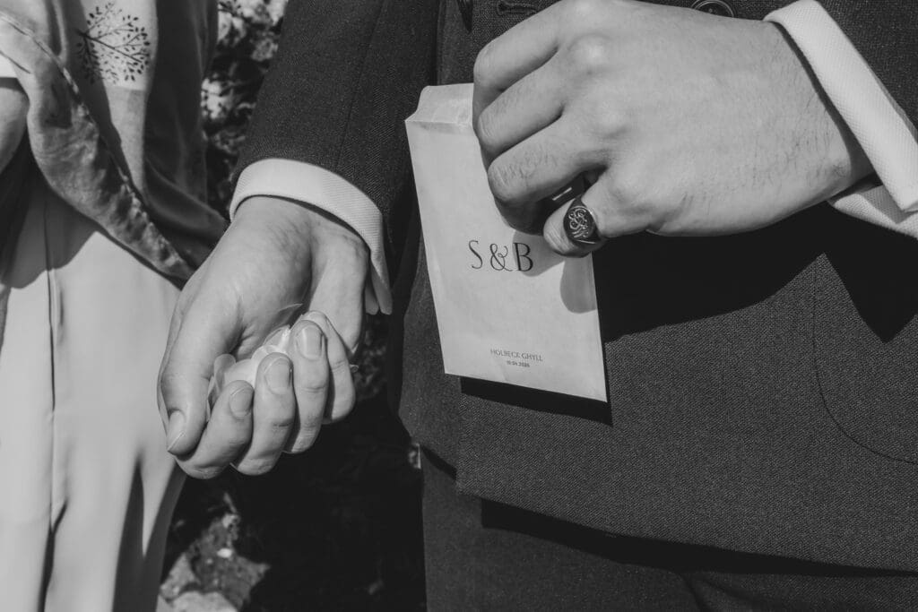 sian and ben's wedding confetti in hand